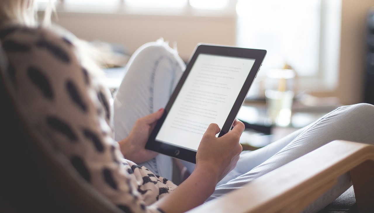 Girl reading on a kindle. 