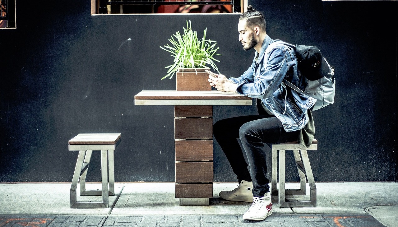 Millennial guy checking his phone. 