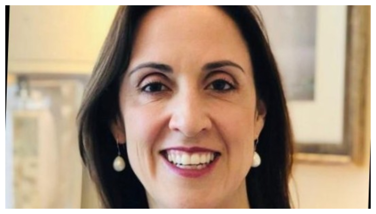 Aura Cuellar, a Colombian woman shown from the neck up. She has brown hair, is facing the viewer, and is smiling.