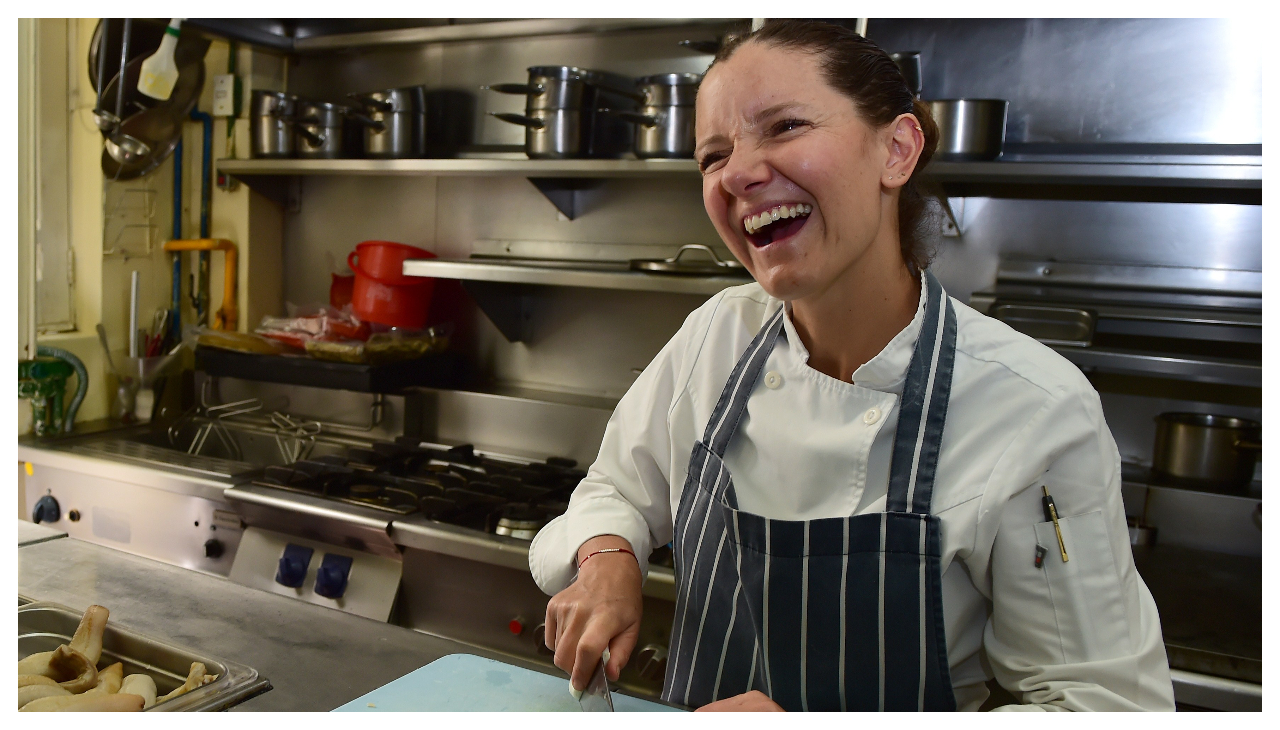 Elena Reygadas, in a restaurant kitchen. She is laughing.