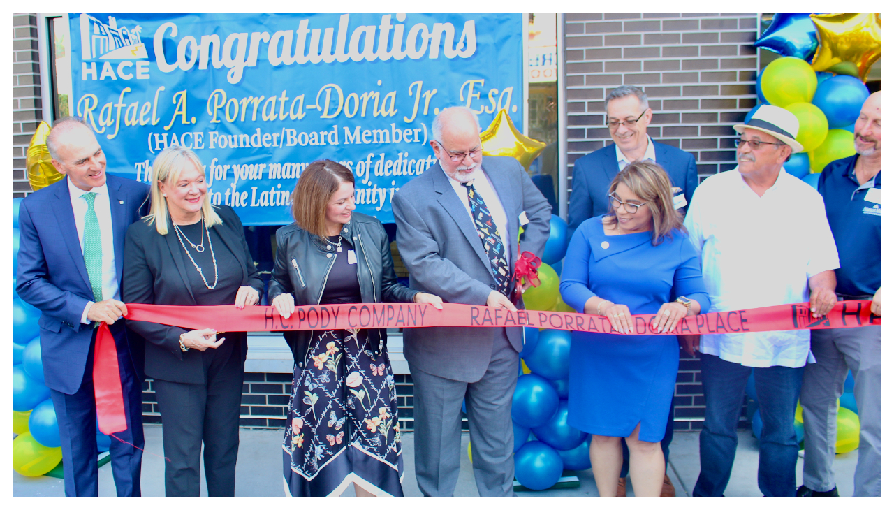 Rafael Porrata-Doria, surrounded by peers as he cuts the ribbon before Rafael Porrata-Doria Place.