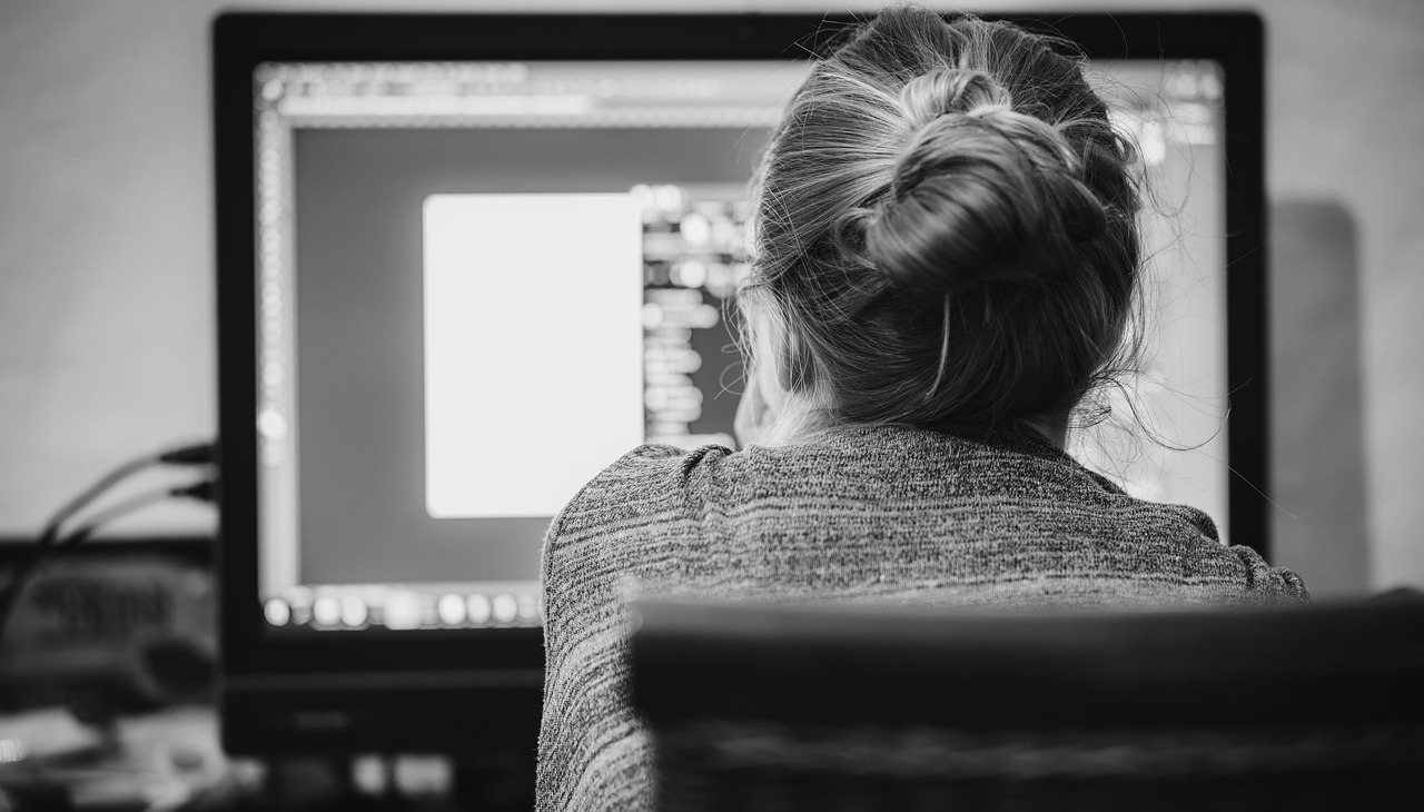 Woman checking the screen of her pc.