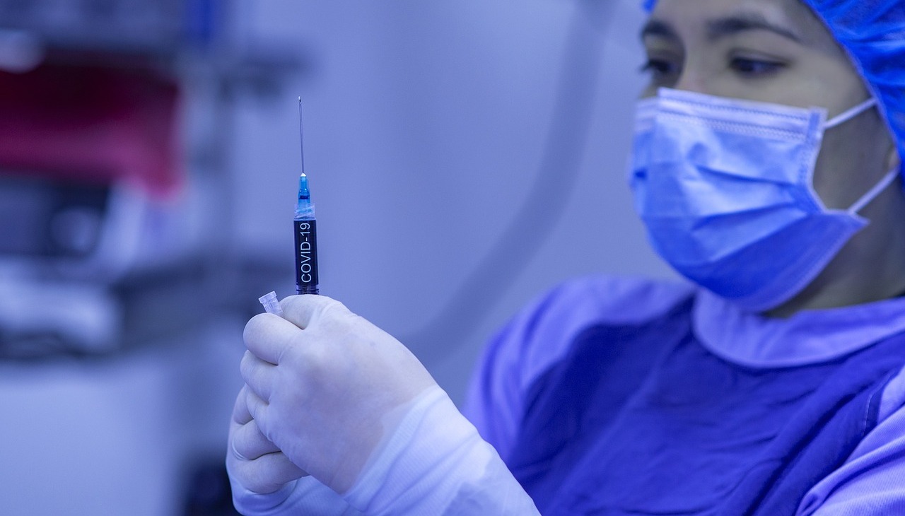 A nurse holding a syringe.