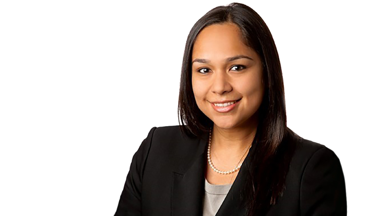 Natalie Gonzales, a Latina woman with shoulder length black hair, shown from the shoulders up. She is facing the viewer and is smiling.