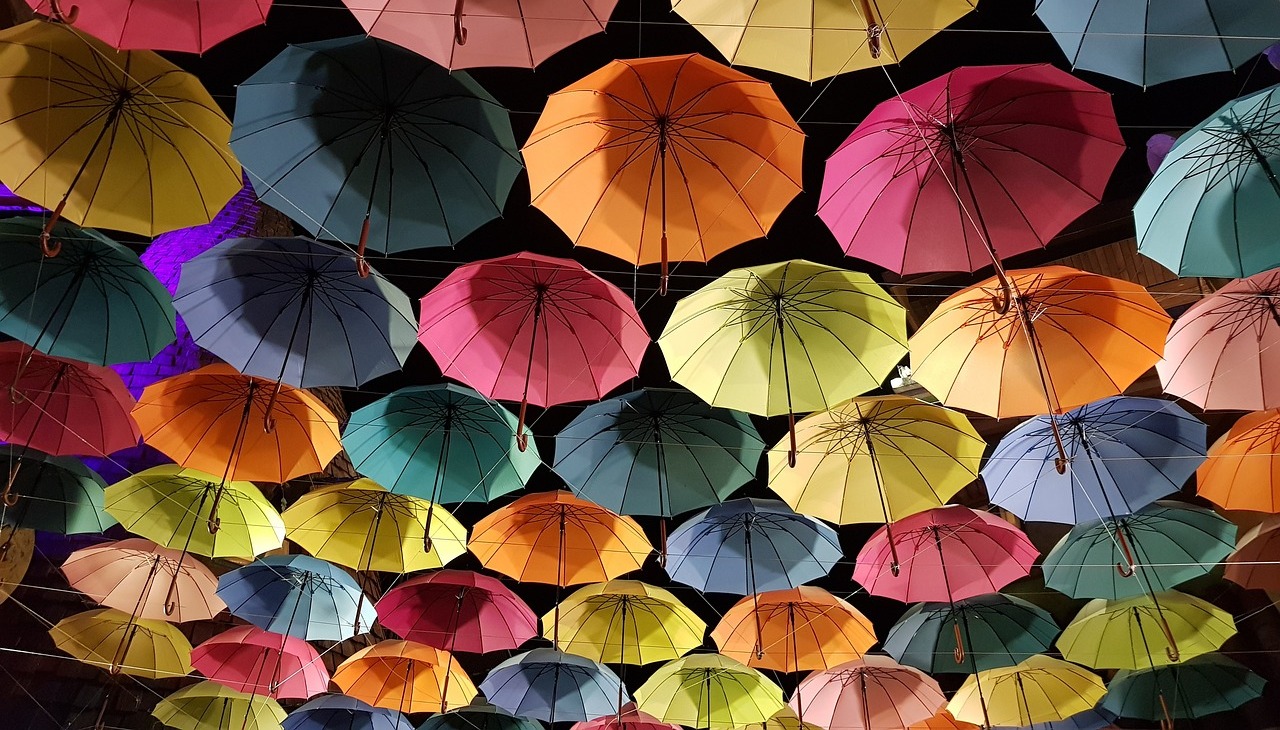 colorful umbrellas hanging on the street.