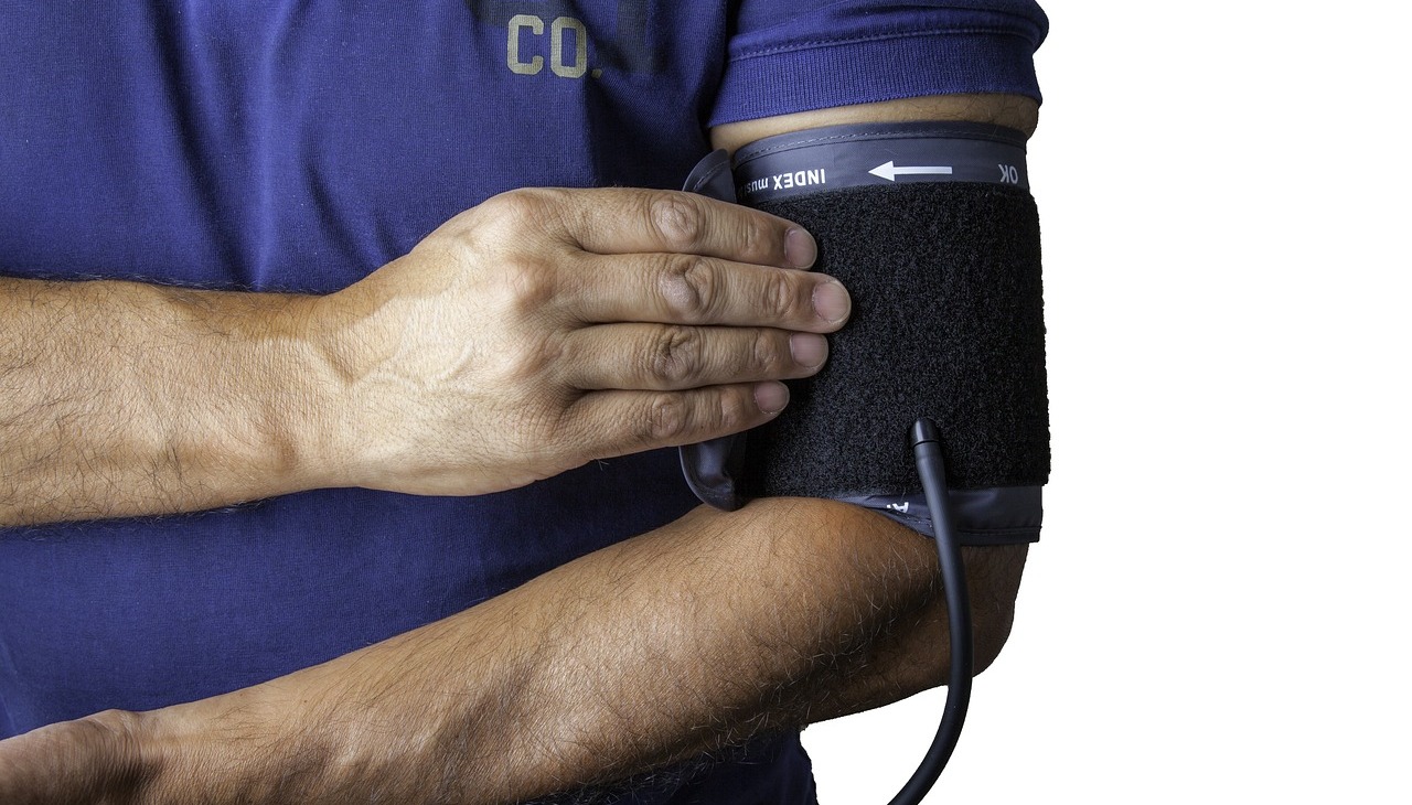 Doctor measuring his blood pressure. 