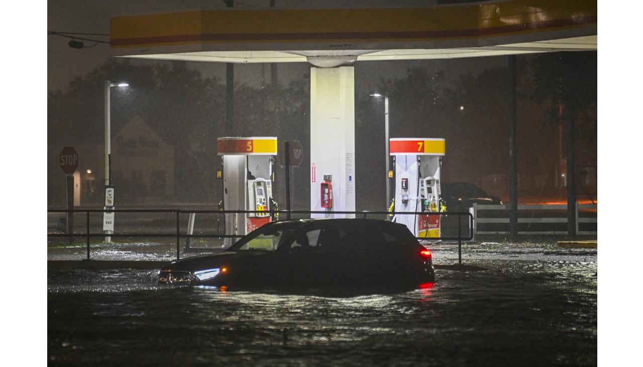 A vehicle is stranded on a water-flooded street after Hurricane Milton made landfall in Brandon, Florida. Photo by Miguel J. Rodriguez Carrillo / AFP