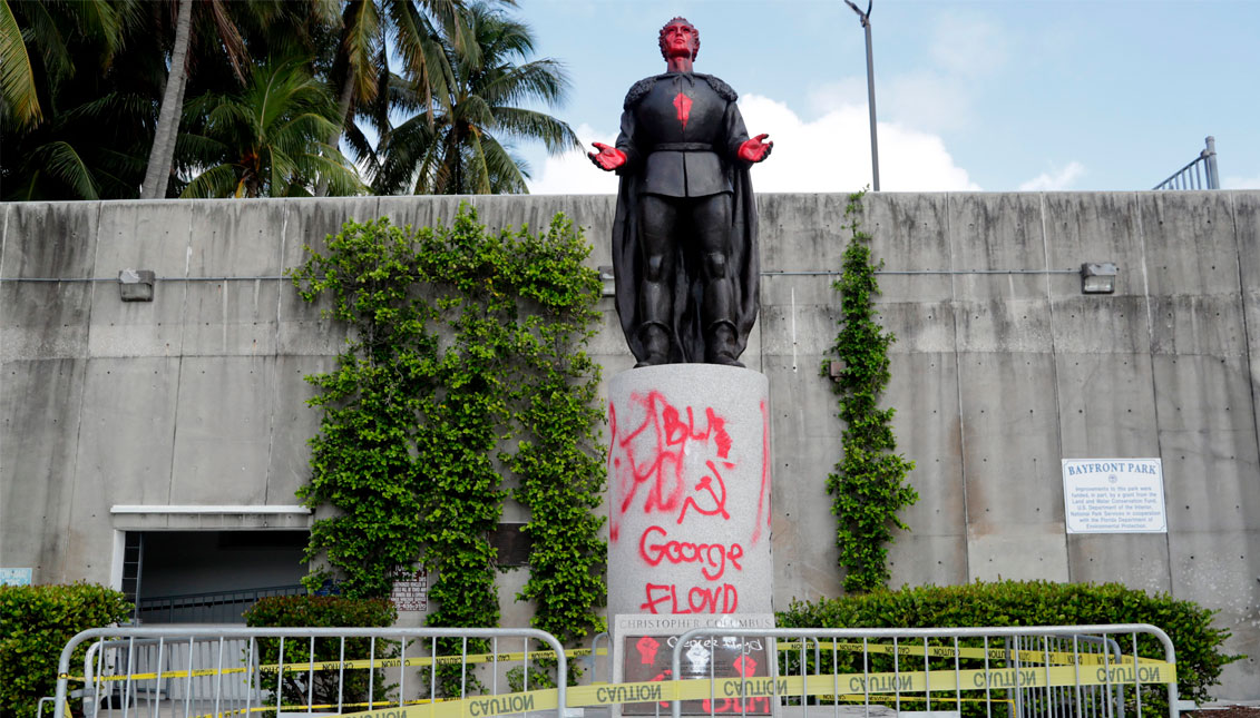 A statue of Christopher Columbus is shown vandalized at Bayfront Park in Miami, Thursday, June 11, 2020. Miami police say that several people were arrested for vandalizing the statue of Columbus and Juan Ponce de León during a protest Wednesday. Protests continue over the death of George Floyd, a black man who died last month while in police custody in Minneapolis.(Source: AP Photo/Lynne Sladky)