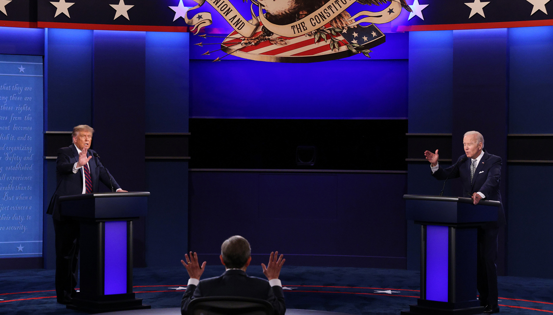 U.S. President Donald Trump and Democratic presidential nominee Joe Biden participate in the first presidential debate moderated by Fox News anchor Chris Wallace (C) at the Health Education Campus of Case Western Reserve University on September 29, 2020 in Cleveland, Ohio. (Photo by Scott Olson/Getty Images)