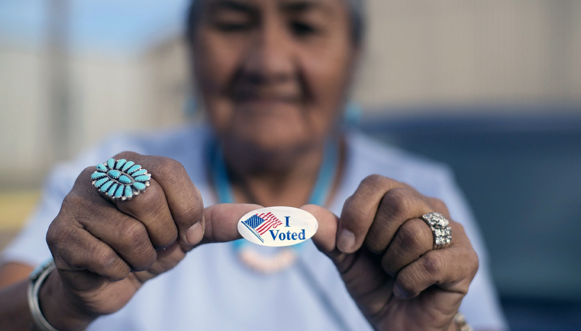 A voter shows her ‘I Voted’ sticker while waiting for the Navajo Nation presidential primary election results in 2018 in Window Rock, Arizona. Photo: CAYLA NIMMO/AP PHOTO