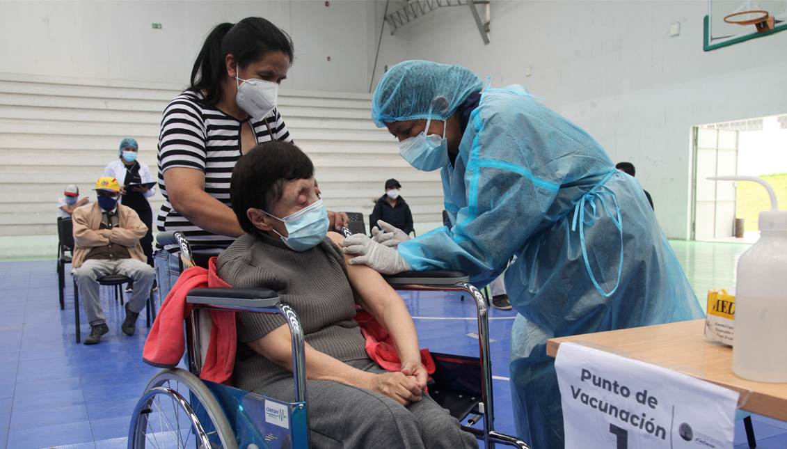 CUENCA, ECUADOR - APRIL 26: A health worker administers a dose of the Sinovac vaccine to a person with disability as part of the vaccination campaign against COVID-19 at Coliseo de la Unidad Educativa Garaicoa on April 26, 2021 in Cuenca, Ecuador. (Photo by Xavier Caivinagua/Agencia Press South/Getty Images)
