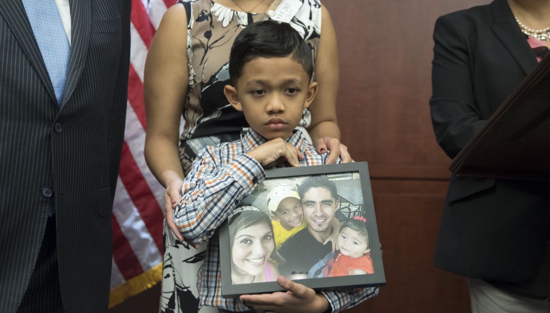 Seven-year-old Walter Escobar of Texas holds a photo of his family, including his father Jose Escobar that was deported from the US; at a news conference held by US Democratic Senators, the National Council of La Raza and immigration advocates, on Capitol Hill in Washington, DC, USA, 28 March 2017. EPA/MICHAEL REYNOLDS
