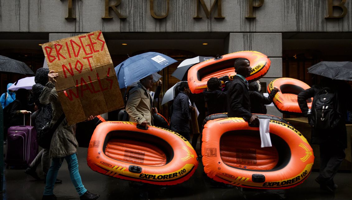 People carrying inflatable rafts, a form of transportation used by refugees, march against the Trump administration's proposed immigration and refugee policies in front of a Trump Building in lower Manhattan in New York, New York, USA, 28 March 2017. EPA/JUSTIN LANE