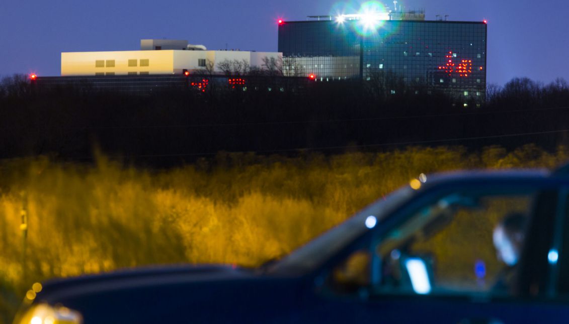  The headquarters of the National Security Agency (NSA) is seen behind a Maryland State Trooper, who is sitting in an unmarked SUV in an empty parking lot, in Fort Meade, Maryland, USA, 22 December 2013. EPA/JIM LO SCALZO
