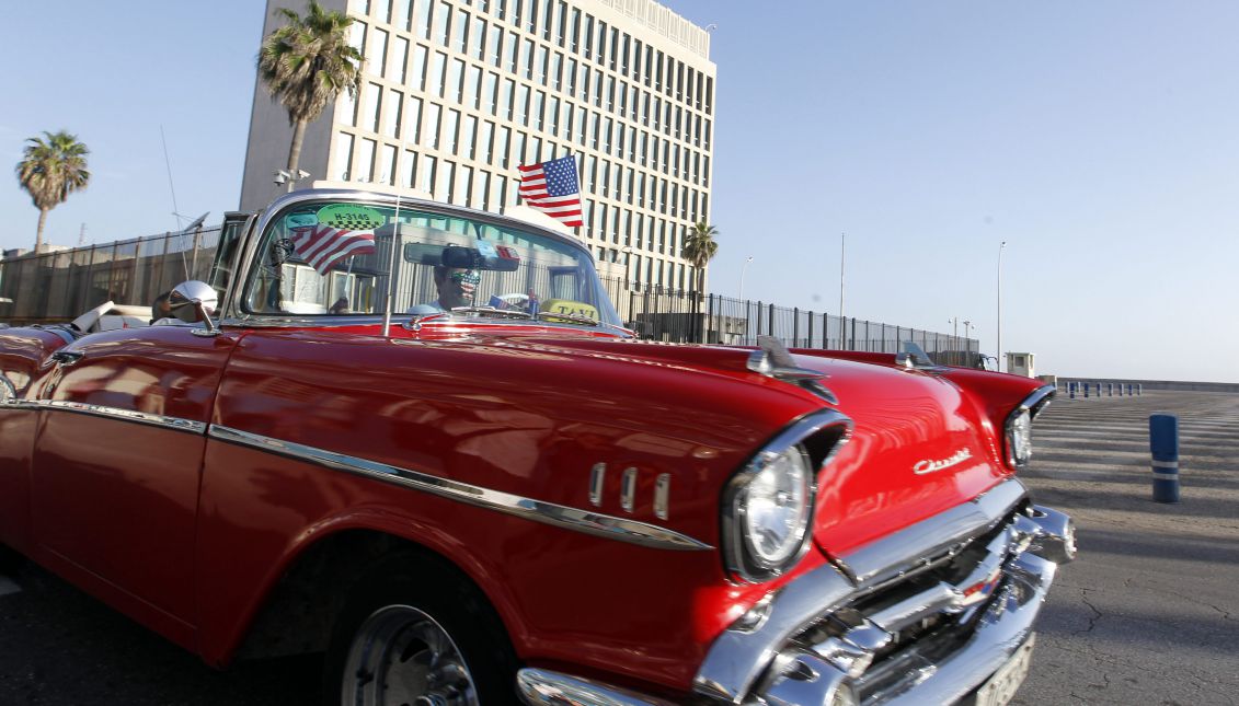 A file picture showing a classic car with the flag of the USA passing by the Office of US interests in Cuba, in Havana, Cuba, July 20, 2015. EPA/ERNESTO MASTRASCUSA