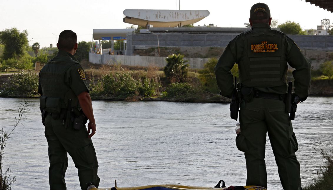 United States Border Patrol (USBP) agents stand beside a raft, reportedly used by people to cross the river, under the bridge along the Rio Grande River near Rio Grande City, Texas, USA, 01 March 2017. EPA/LARRY W. SMITH