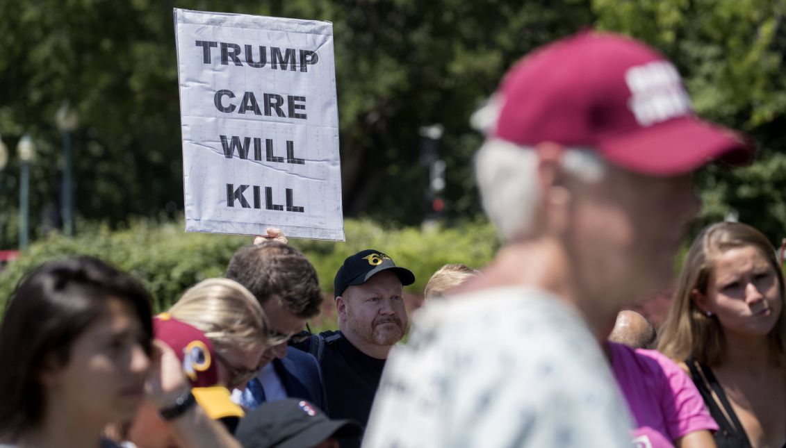 Spectators listen as US Democratic Senator from New Jersey Bob Menendez delivers remarks at a press conference in opposition to the Senate Republican health care bill on the US Capitol grounds in Washington, DC, USA, 28 June 2017. EPA/SHAWN THEW