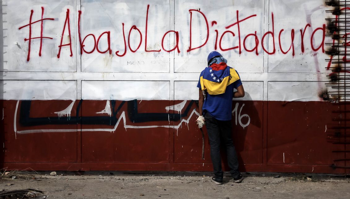 A protester holds rocks in his hands during riots with members of the National Bolivarian Guard (GNB) in Caracas, Venezuela, 27 July 2017. EPA/MIGUEL GUTIERREZ