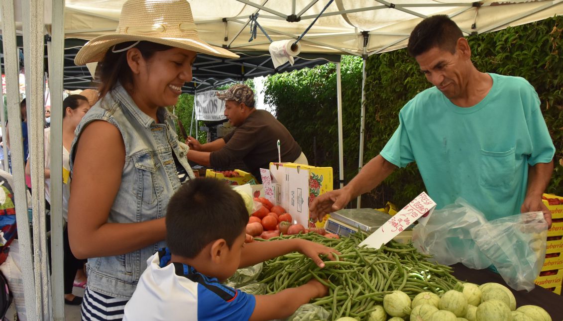 Carmen Hernandez (r.), seen with her son Alexander Rodriguez, at a farmers' market in Los Angeles on July 27, 2017, where they benefit from the FVRx (Fruit and Vegetables Prescription program) that provides fruit and vegetables for people suffering health problems that stem from malnutrition. EFE/Ivan Mejia
