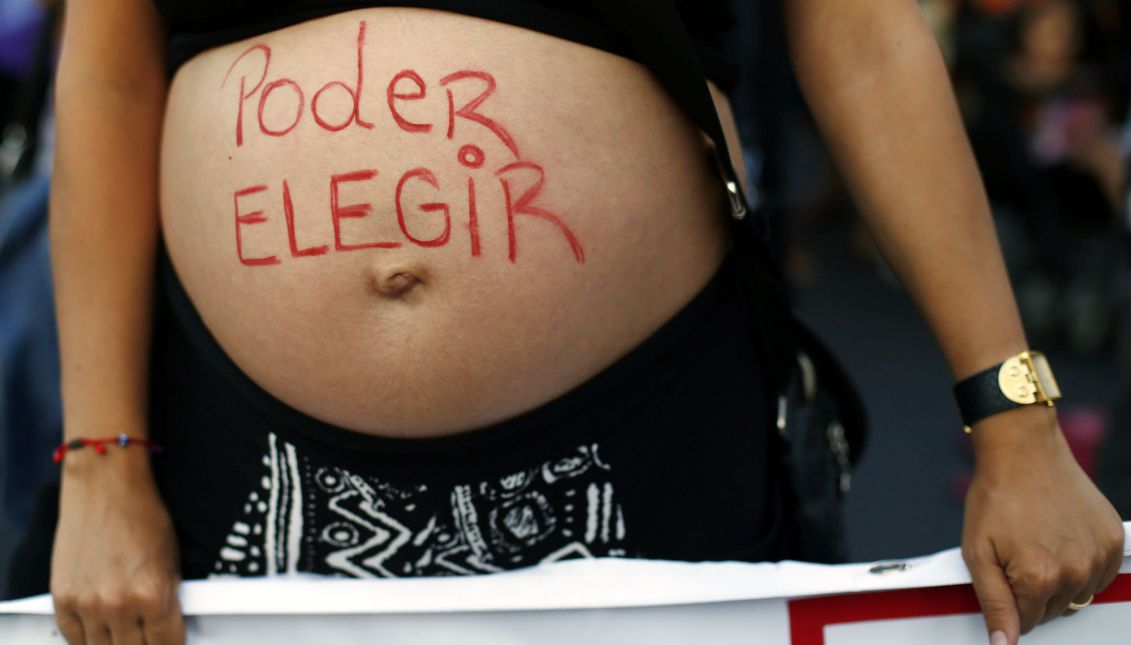 Demonstrators participate in a march in order to commemorate the International Women's Day in Santiago de Chile, Chile, 08 March 2016, where they asked for the end of discrimination and the decriminalization of abortion. The text reads ' I can choose'. EPA/MARIO RUIZ