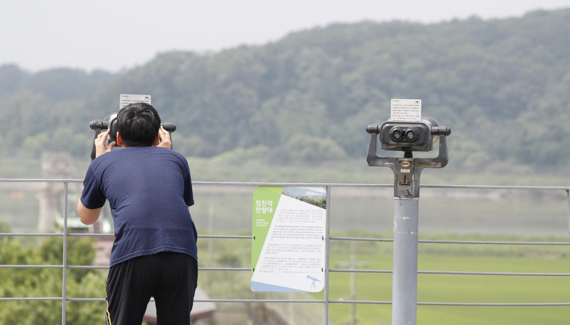 A visitor looks through binoculars at North Korea from Imjingak, near the Demilitarized Zone (DMZ) in Paju, Gyeonggi-do, South Korea, 09 August 2017. EPA/JEON HEON-KYUN