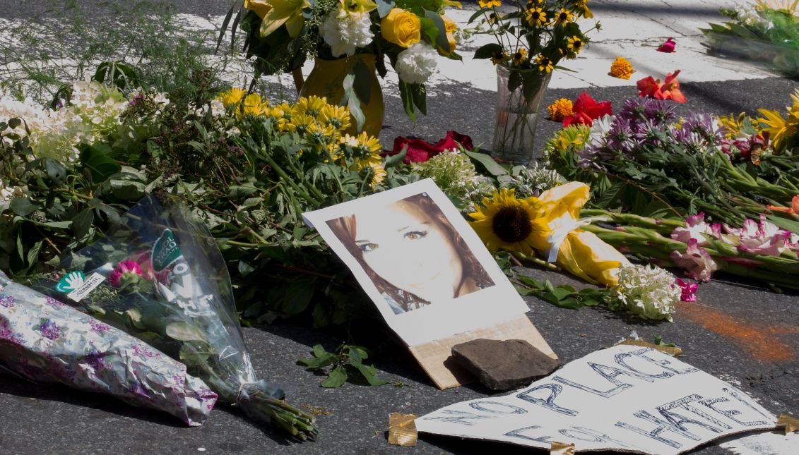 People place flowers at the corner of Fourth and East Water Street in Charlottesville, Virginia, USA, 13 August 2017. A woman killed when a car slammed into counter-protesters at that intersection following the cancelation of a planned white supremacist march in that city was identified on 13 August 2017 by authorities as 32-year-old Heather Heyer. EPA/TASOS KATOPODIS
