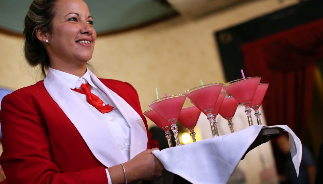 A waitress serves several daiquiris at the Floridita bar/restaurant in Havana, Cuba, 16 August 2017. The daiquiri attracts thousands to its birthplace, Floridita, which is marking its 200th anniversary, each year, but perhaps the establishment is best known as having been a frequent hangout of late Nobel literature laureate Ernest Hemingway during his long stays in Cuba. EFE/Alejandro Ernesto