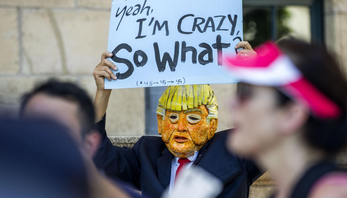 A group of people protest against the immigration policies of President Donald Trump during the visit of Attorney General Jeff Sessions to Miami on Aug. 16, 2017. Sessions urged the local authorities to follow the example set by Miami-Dade County of "punishing, not protecting" criminals during a speech in which he criticized Chicago's policies. EFE/Giorgio Viera
