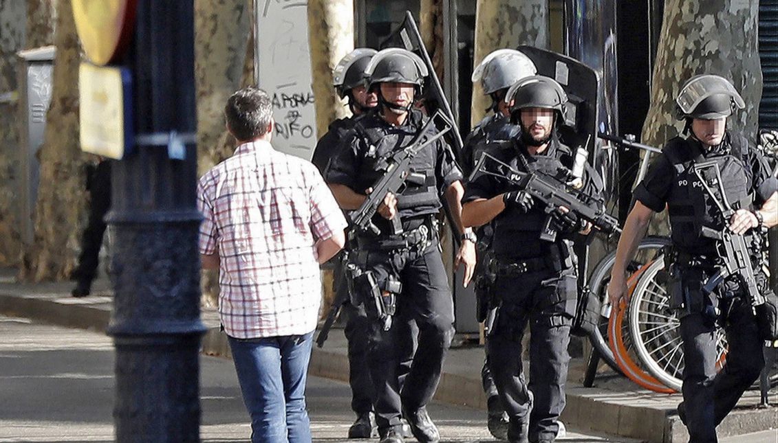 Heavily armed police officers arrive for a manhunt near the site where a van crashes into pedestrians in Las Ramblas, downtown Barcelona, Spain, 17 August 2017. EPA/Andreu Dalmau FACES PIXELATED BY SOURCE DUE TO SPANISH LAW