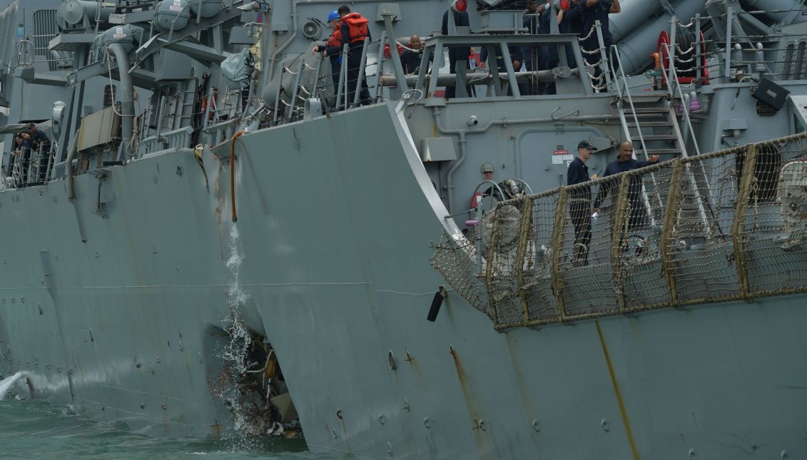 Crewmen on the deck of the United States Navy missile destroyer USS John S McCain above a hole on the port side of its hull as it is towed into the Changi Navy Base off the eastern coast of Singapore, 21 August 2017. EPA/DESMOND FOO/THE STRAITS TIMES/SPH
