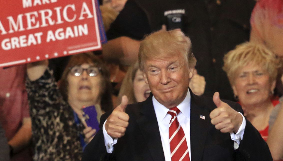 US President Donald J. Trump gives a thumbs up to the crowd as he enters the Phoenix Convention Center for a campaign rally in Phoenix, Arizona, USA, 22 August 2017. EPA/ROY DABNER