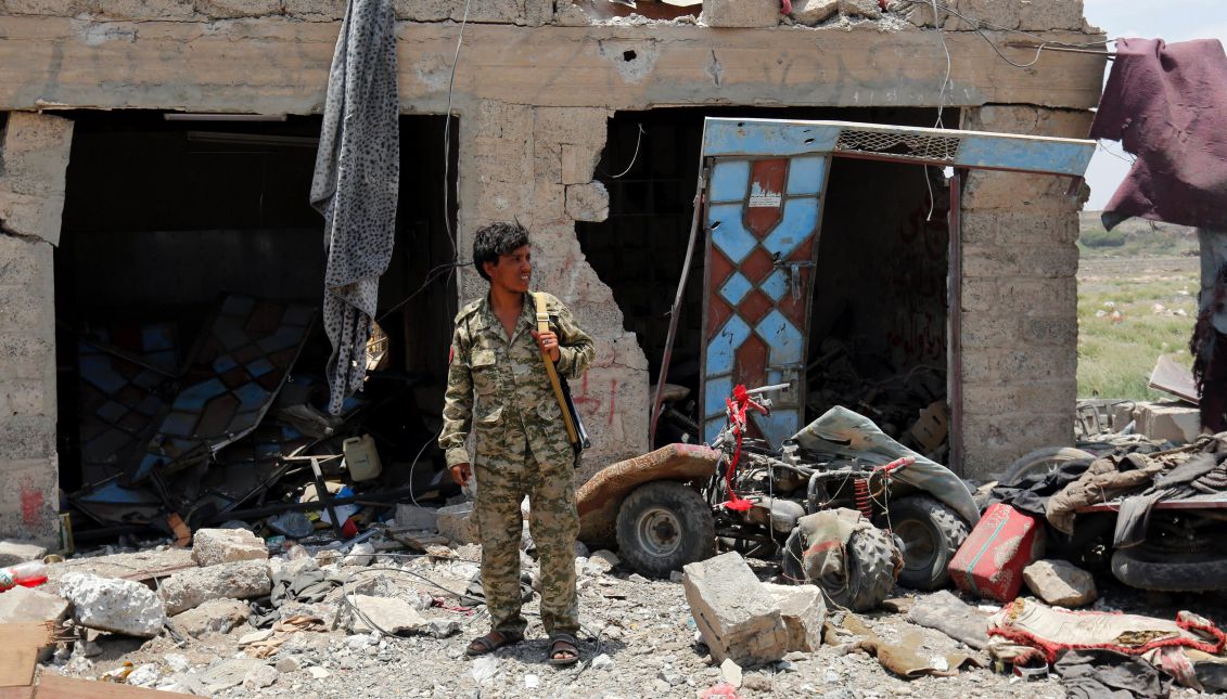 A Houthi militiaman keeps watch near a building after it was allegedly hit by Saudi-led airstrikes on the northern outskirts of Sana'a, Yemen, Aug. 23, 2017. EPA/YAHYA ARHAB
