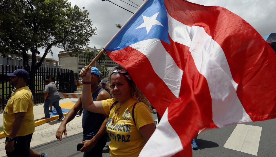 Protesters march against pay cut for public employees, in San Juan, Puerto Rico on Aug. 30, 2017. EPA-EFE/Thais Llorca