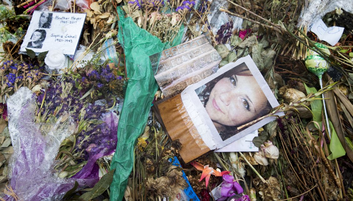 Flowers, candles and other items are placed in memory of Heather Heyer, whose image is seen in this picture, and for those affected by the violence at the site where a vehicle smashed into counter-protesters in Charlottesville, Virginia, USA, 24 August 2017. EPA-EFE FILE/MICHAEL REYNOLDS