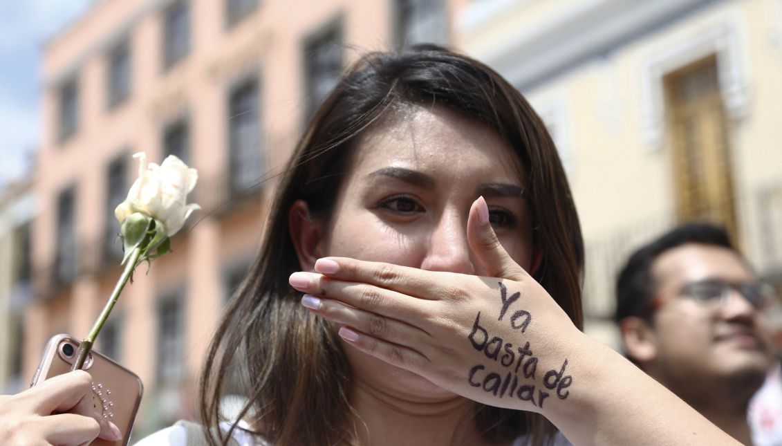 A woman covers her mouth with her hand on which is written "Enough of silence", during a demonstration to reject and demand justice for the murder of Mexican Mara Fernanda Castillo, who was found dead on Sept. 15, 2017 after takin a Cabify Vehicle, in Puebla, Mexico, Sept. 18, 2017. EPA-EFE/Francisco Guasco
