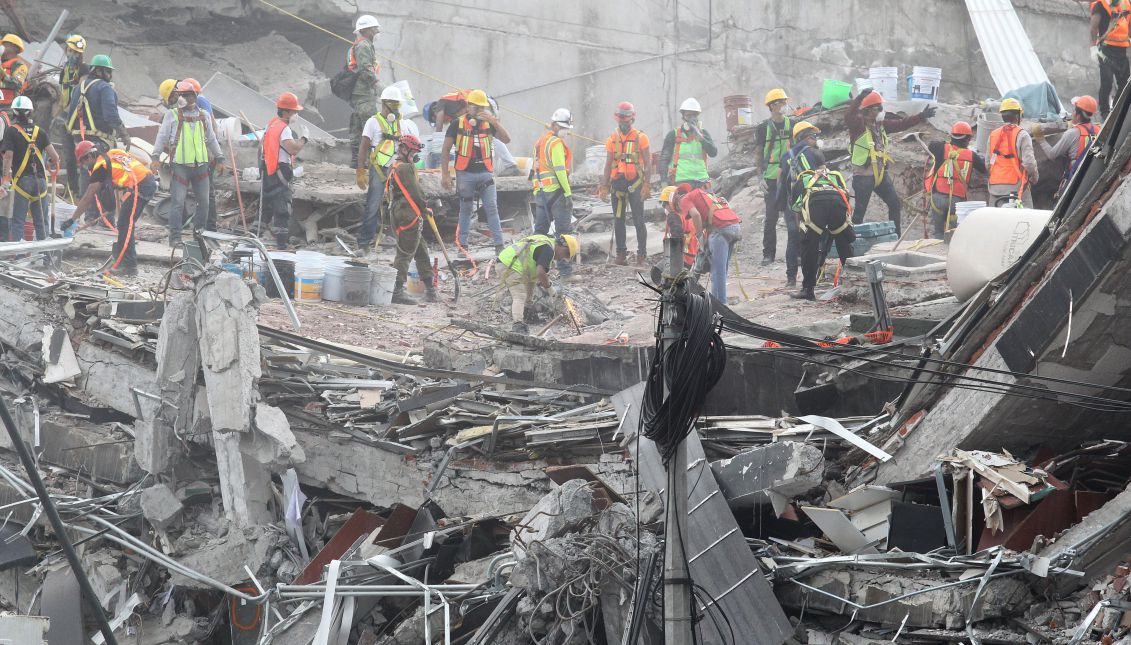 Rescue team members search for victims in the rubble of a collapsed building in the aftermath of a powerful earthquake, in Mexico City, Mexico, Sep. 24, 2017. EPA-EFE/ULISES RUIZ BASURTO
