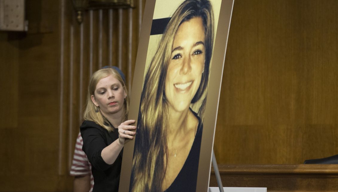 A Congressional staffer puts up a picture of Kathryn Steinle, who was fatally shot in broad daylight on San Francisco's Pier 14 while walking with her father Jim Steinle (not pictured); during Jim Steinle's testimony at the Senate Judiciary Committee hearing on Capitol Hill in Washington DC, USA, 21 July 2015. EPA-EFE FILE/MICHAEL REYNOLDS