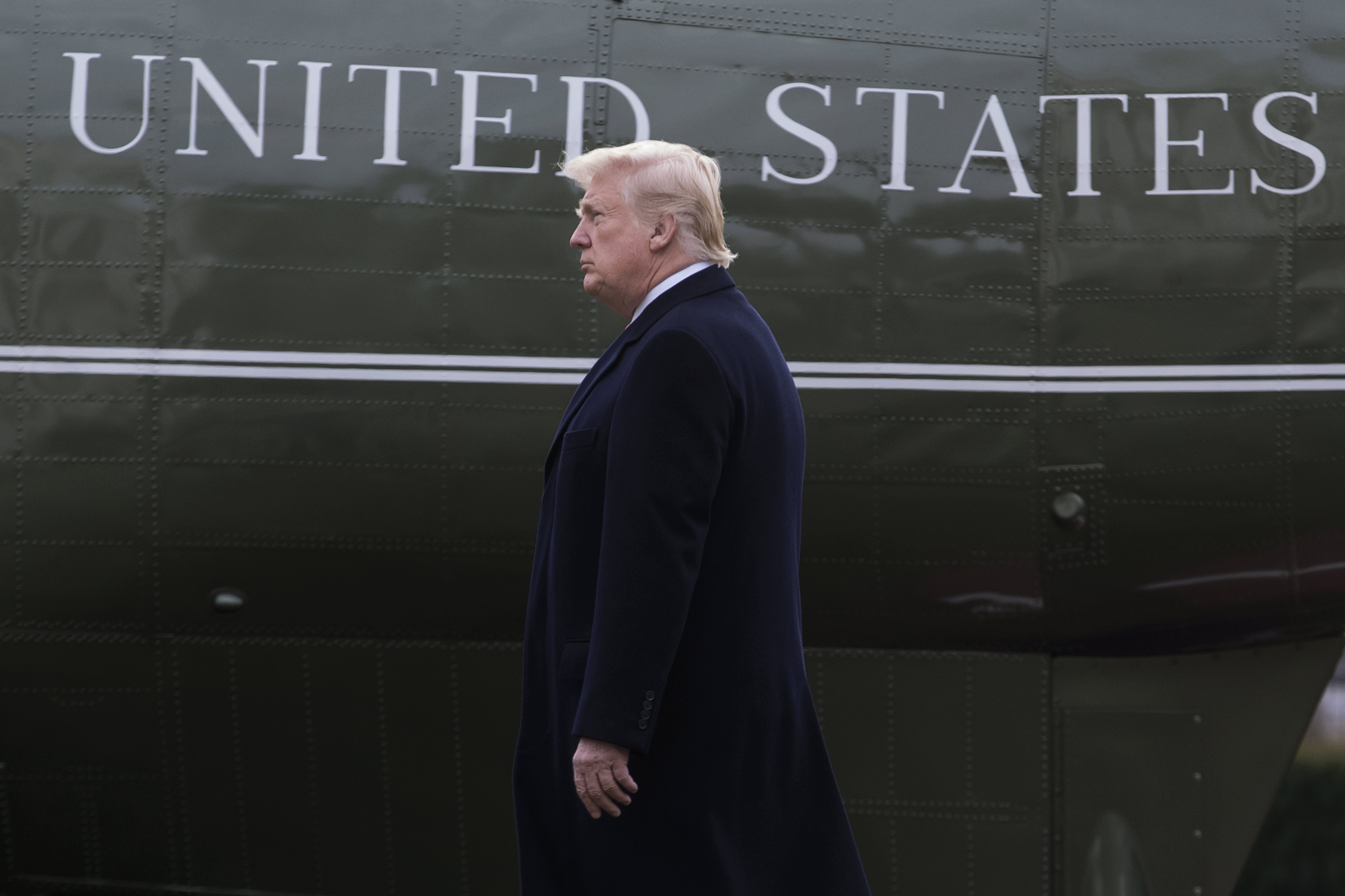 US President Donald J. Trump walks on the South Lawn of the White House to depart by Marine One in Washington, DC, USA, Dec. 22, 2017.