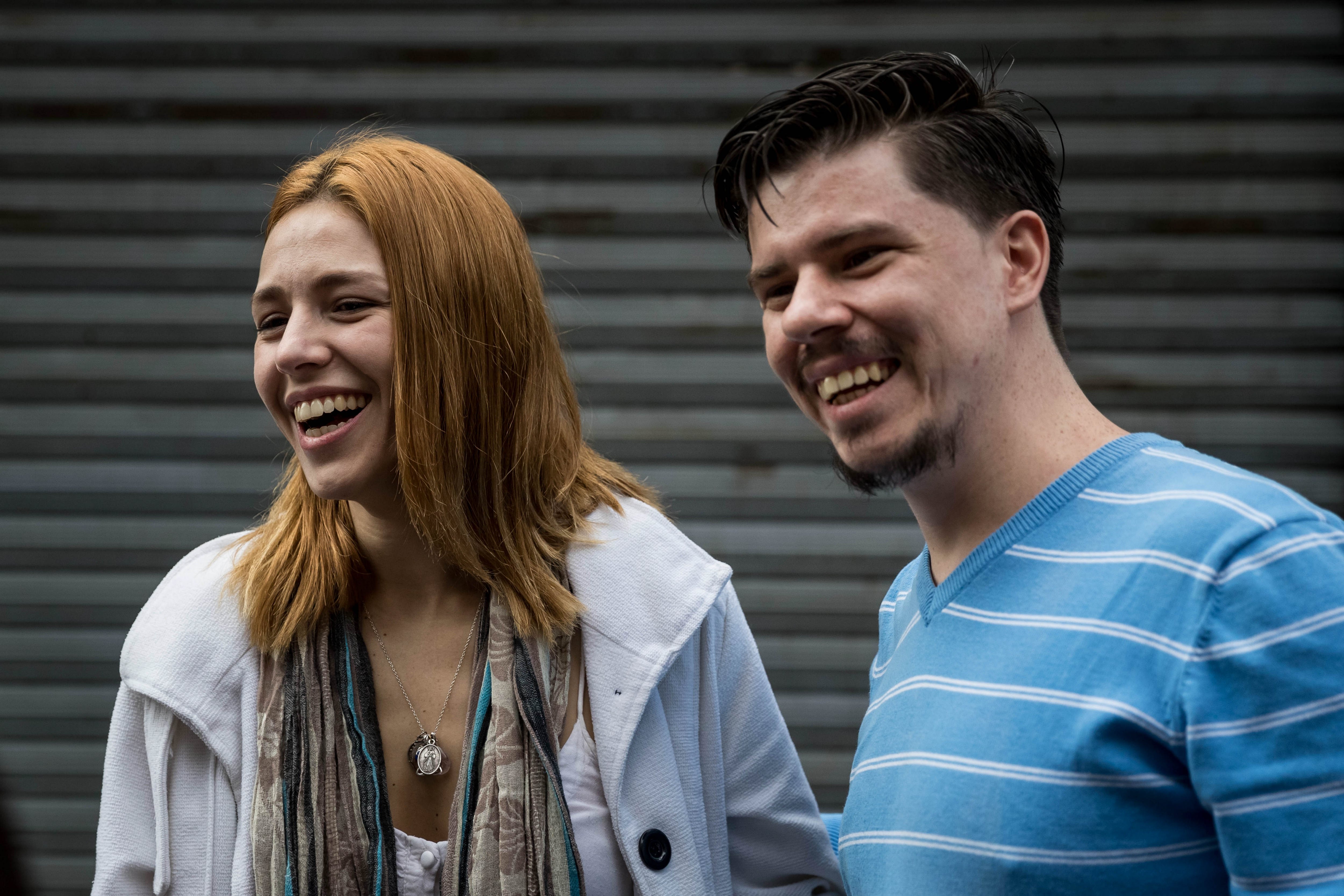 Spanish Andrea Gonzalez (L), a released political prisoner, smiles along with Jhosman Paredes, outside the Palace of Justice in Caracas, Venezuela, Dec. 26, 2017.
