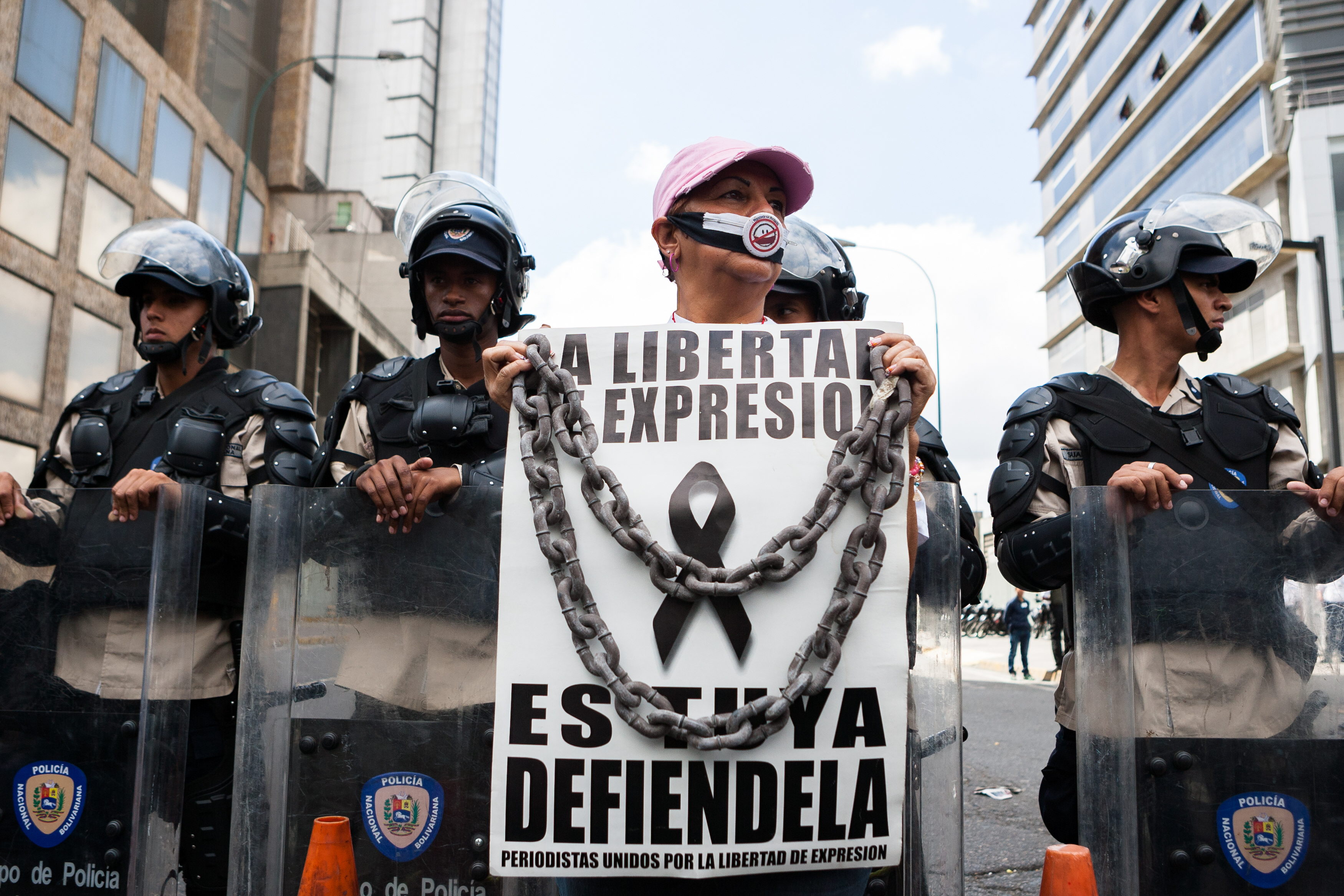 An undated photograph showing a demonstrator holding a sign supporting freedom of the press during a protest in Caracas, Venezuela. EFE FILE
