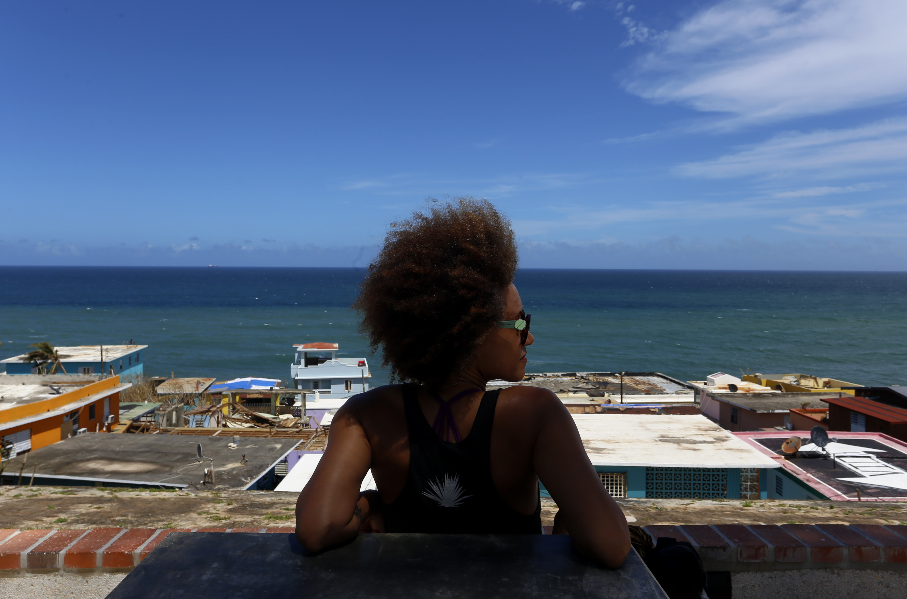 A resident looks at the damages caused by Hurricane Maria, at the neighborhood La Perla of San Juan, Puerto Rico, Sept. 29, 2017.