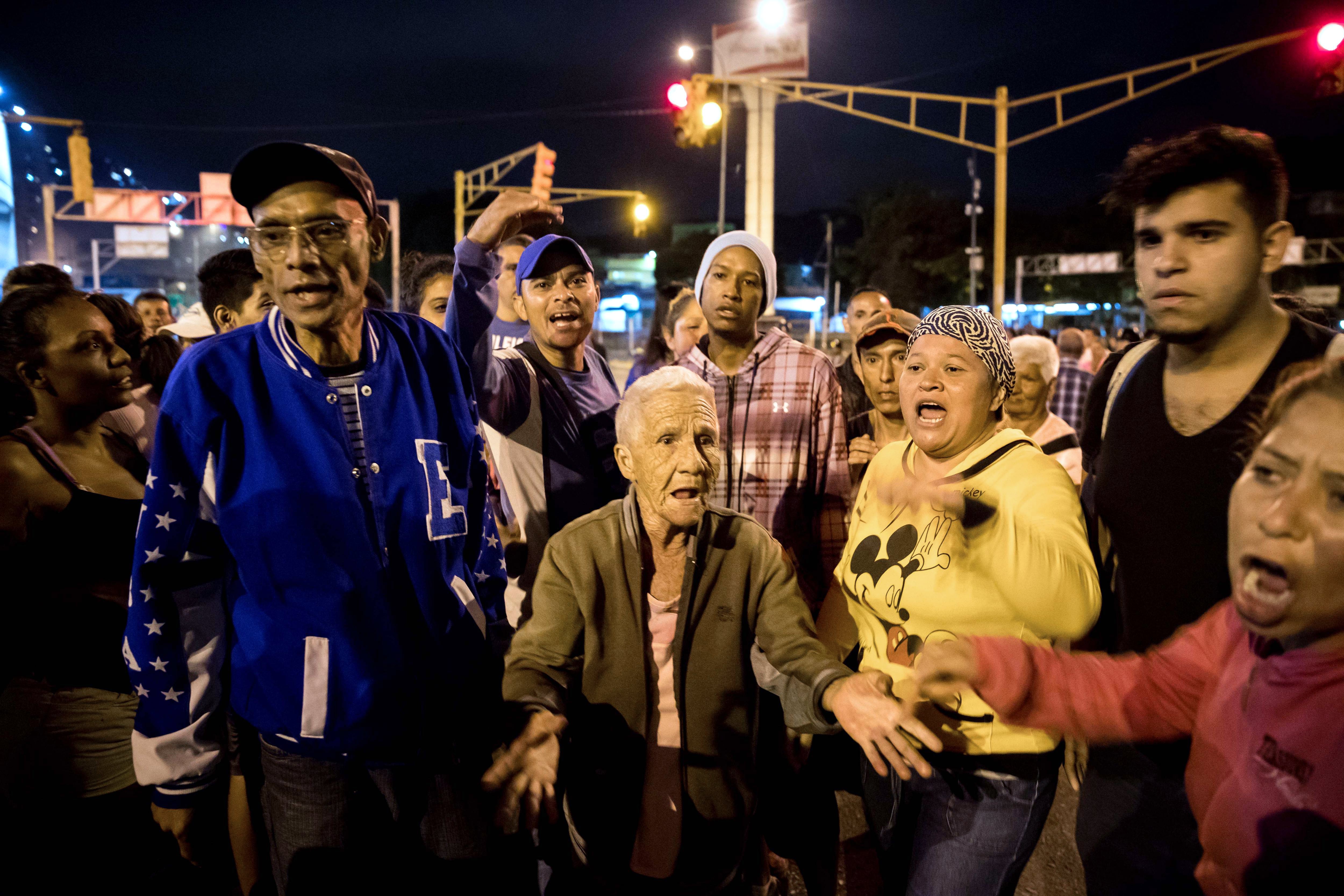 Demonstrators protest over shortages of gas, water and food for holiday meals, in Caracas, Venezuela, Dec. 27, 2017.