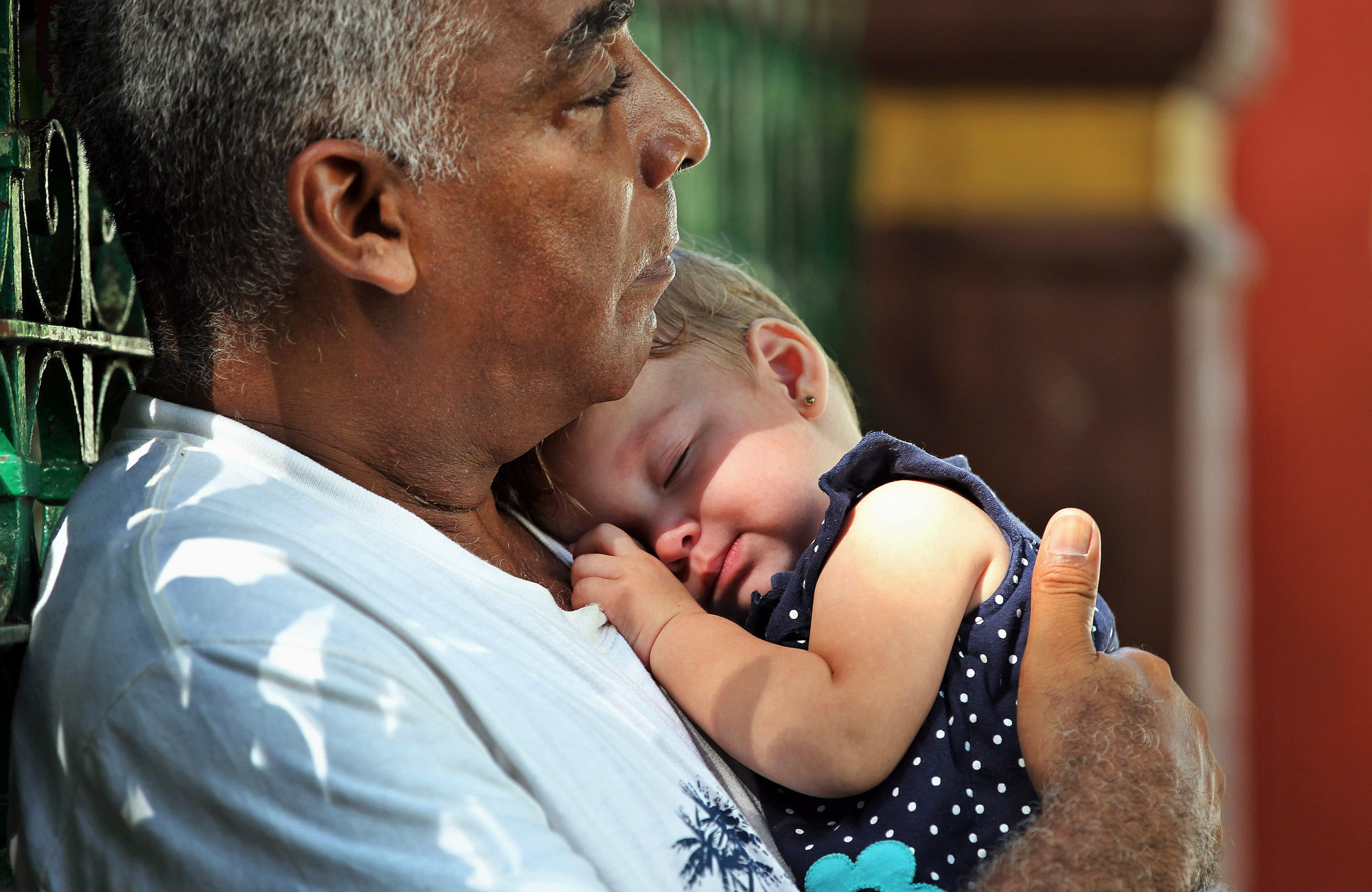 A man carries a baby in Havana, Cuba, Jun. 25, 2015.