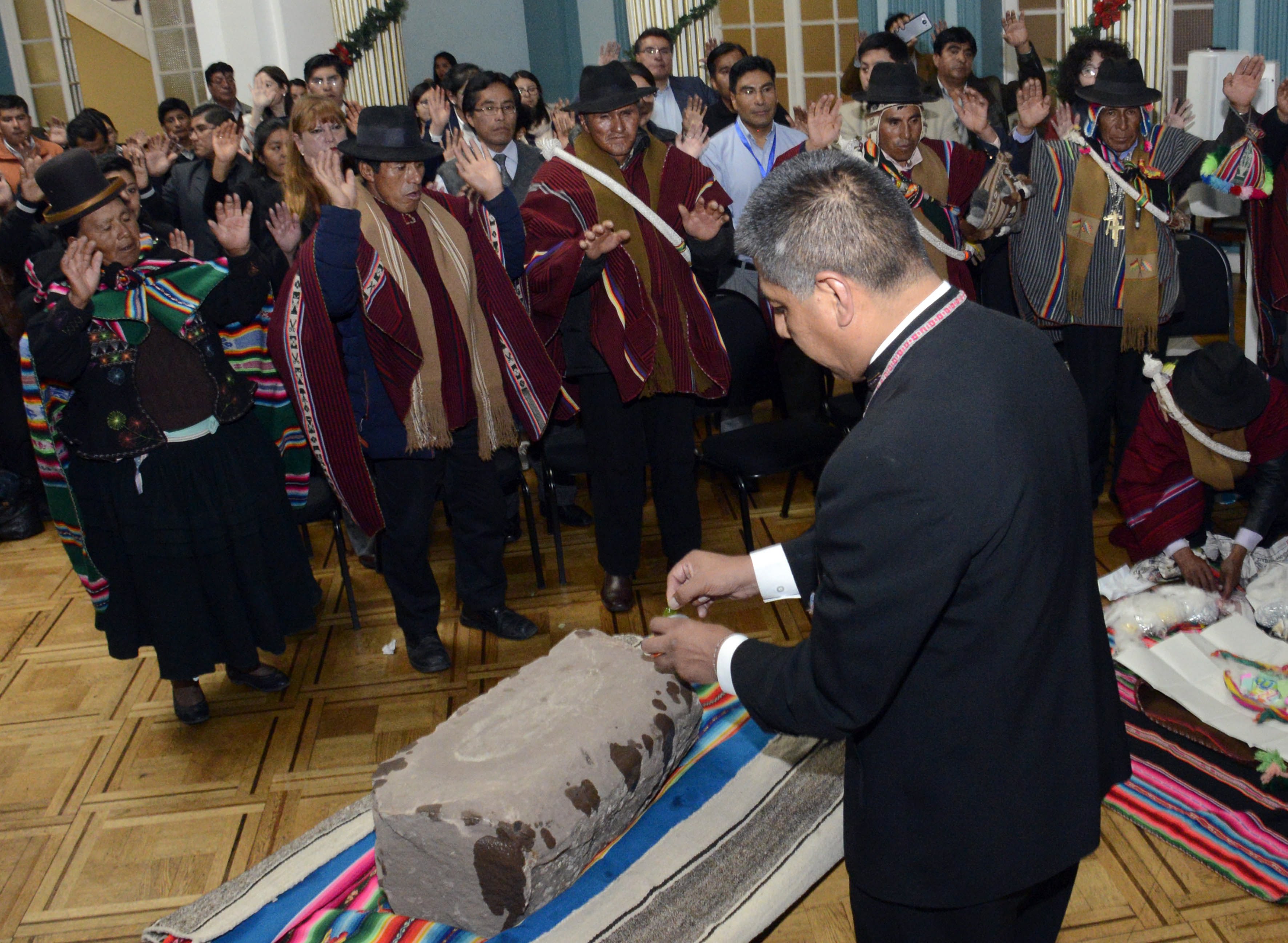 Photo made available by the Bolivian Information Agency (ABI) shows Bolivian Foreign Minister, Fernando Huanacuni (R), participating in the delivery of the world's oldest human footprint set in stone to the Bolivian Sullkatiti community in La Paz, Bolivia, Dec. 29, 2017.
