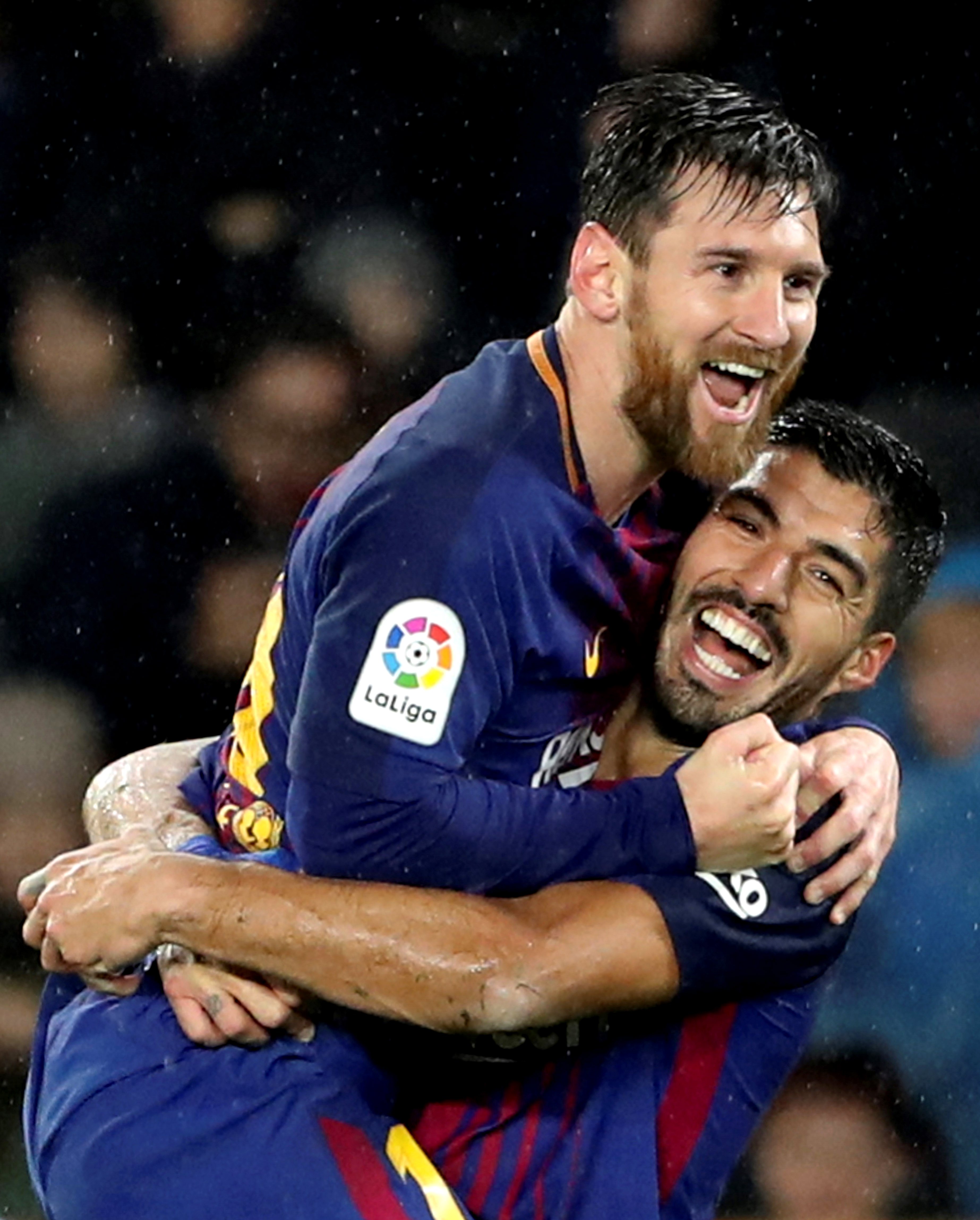 FC Barcelona's Argentinian forward Leo Messi (R) celebrates with Uruguayan forward Luis Suarez after scoring the 2-4 lead against Real Sociedad during the Primera Division Liga match held between Real Sociedad and FC Barcelona at Anoeta stadium in San Sebastian, Basque Country, Spain, 14 January 2018.