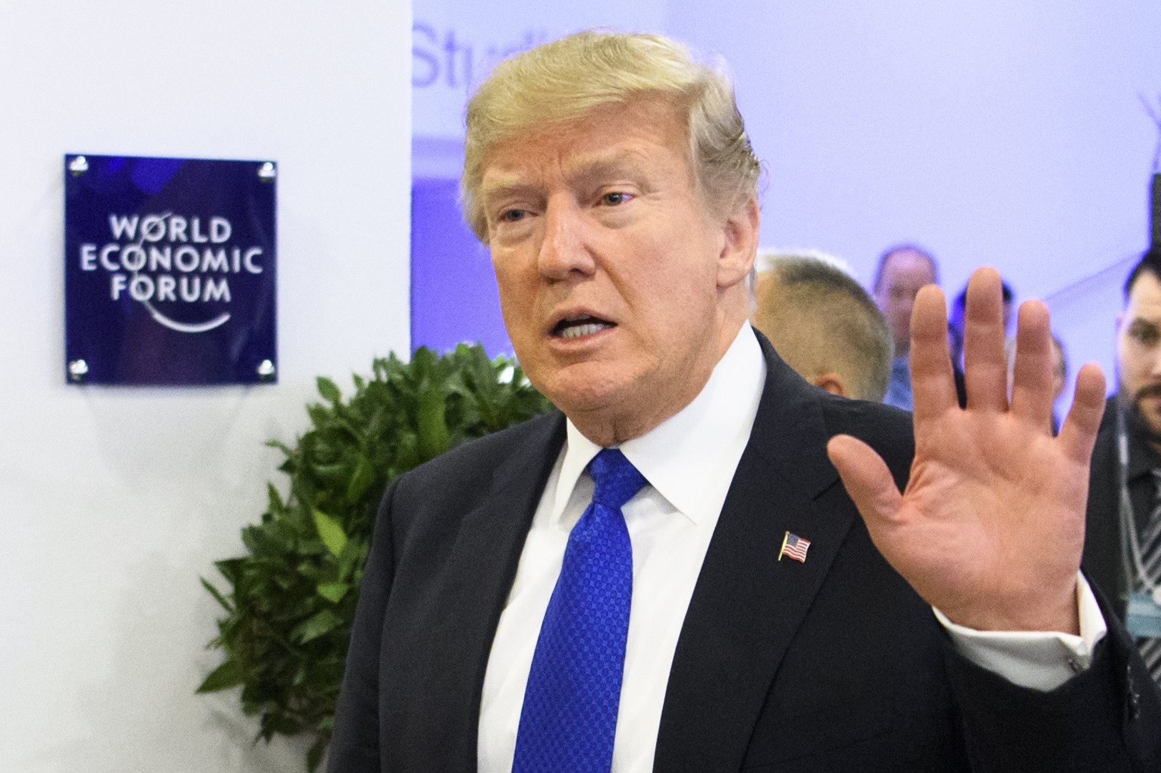 US President Donald J. Trump waves as he walks in the corridors after a meeting during the 48th Annual Meeting of the World Economic Forum (WEF), in Davos, Switzerland, Jan. 25, 2018.
