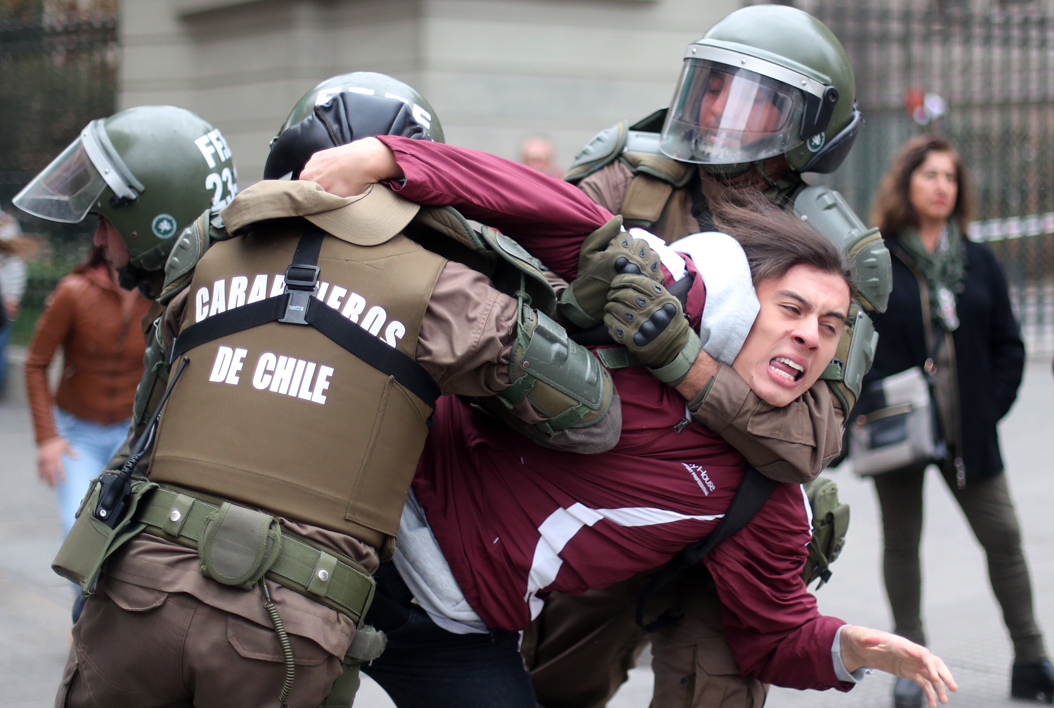 A young man is arrested by the police during a protest against gender violence in Santiago, Chile, May 16, 2018. EPA-EFE/MARIO RUIZ
