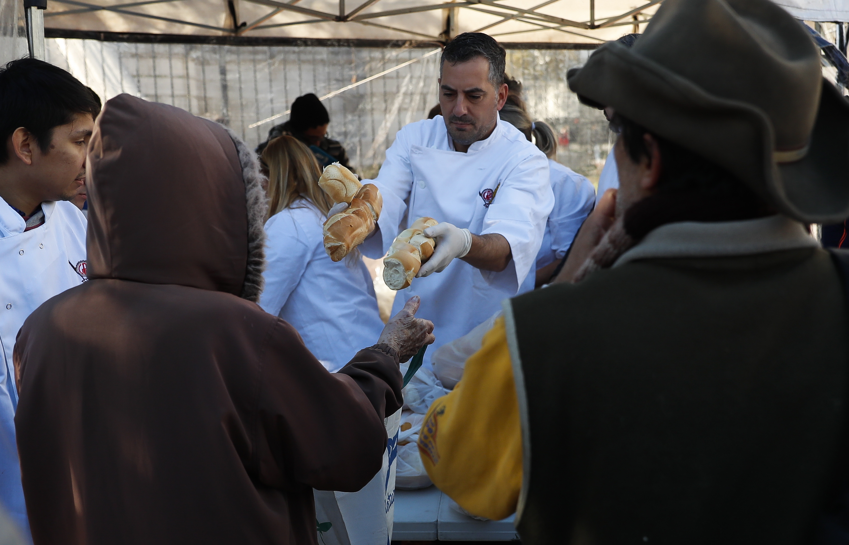 Argentinian bakers protest the rise in the price of flour by giving away five tons of bread, in front of the Congress in Buenos Aires, Argentina, June 6, 2018. EPA-EFE/David Fernandez