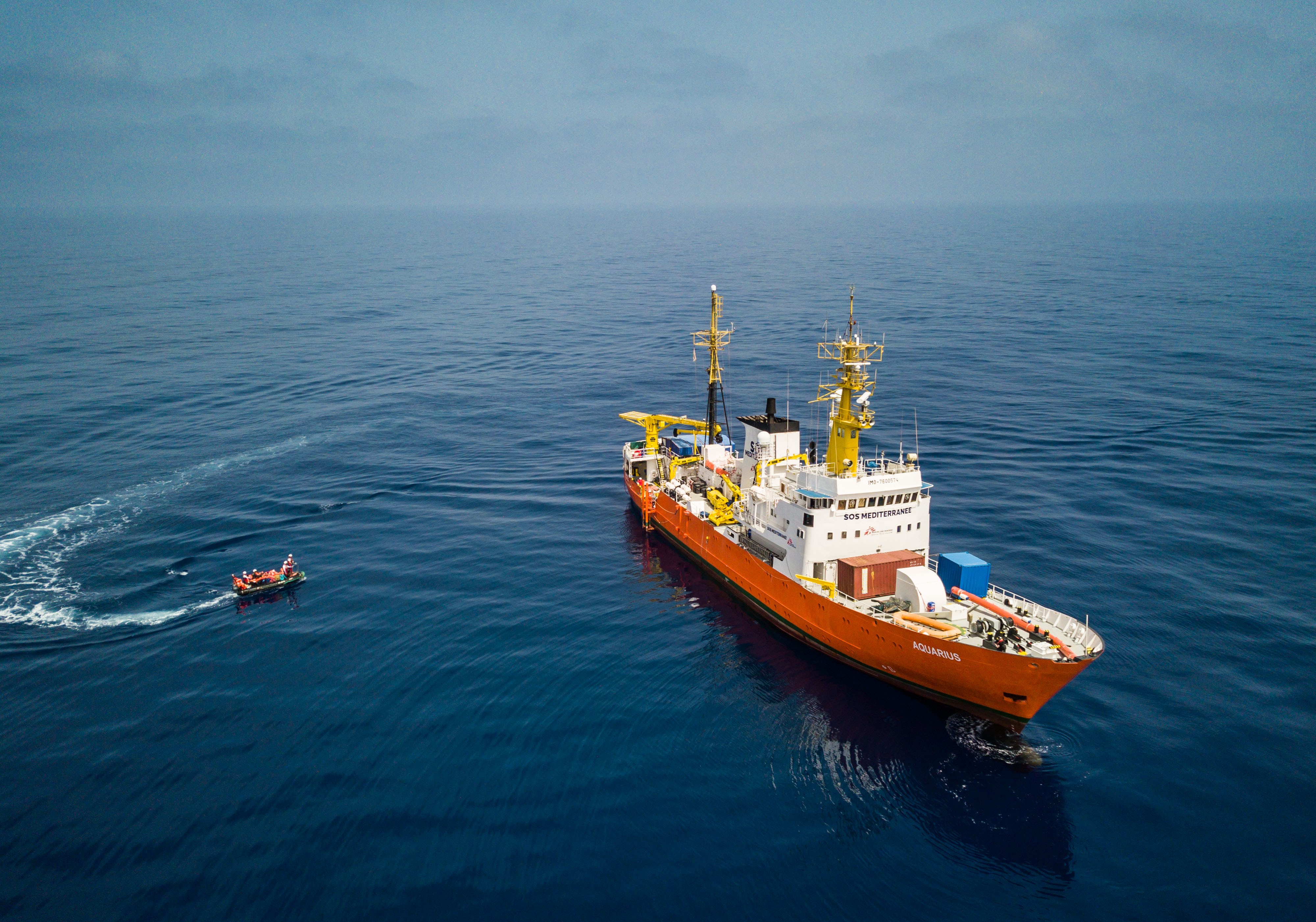 A picture taken by a drone shows members of the NGO 'SOS Mediterranee' from the 'Aquarius' vessel lead an operation to rescue more than 250 migrants on a wooden boat, about 50 kilometers off the Libyan coast, in the Mediterranean Sea, April 21,l 2018. EPA-EFE/FILE/CHRISTOPHE PETIT TESSON