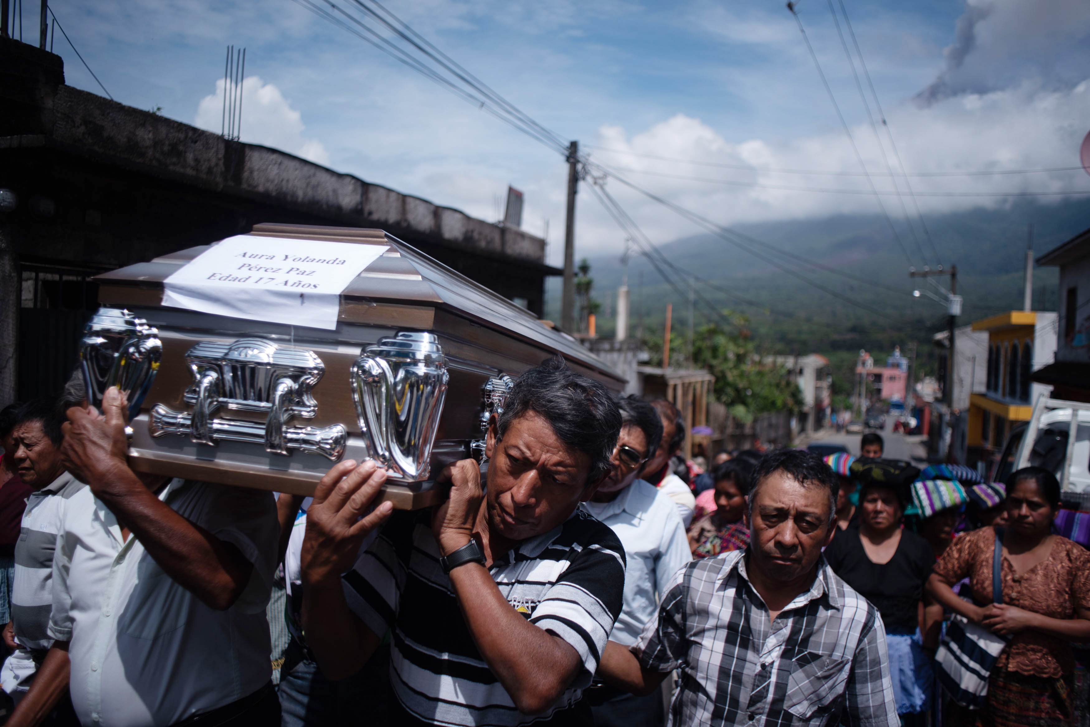 People attend the burial of Aura Yolanda Perez Paz, 17, who died in San Miguel Los Lotes during the volcanic eruption, in the municipality of Alotenango, Department of Sacatepequez, Guatemala, 12 June 2018. EFE